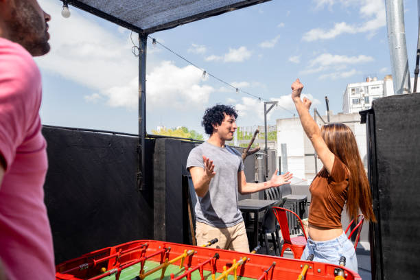 istock Couple celebrating during foosball match in a hostel 2206072524