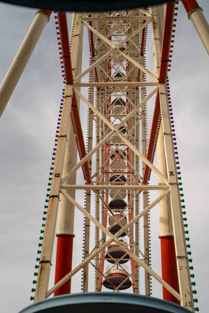 istock Giant Ferris wheel towering view, amusement park attraction, industrial structure, geometric steel framework, engineering symmetry, urban entertainment ride 2206073628