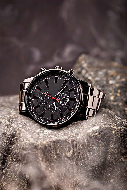 Luxury stainless steel watch on rugged stone