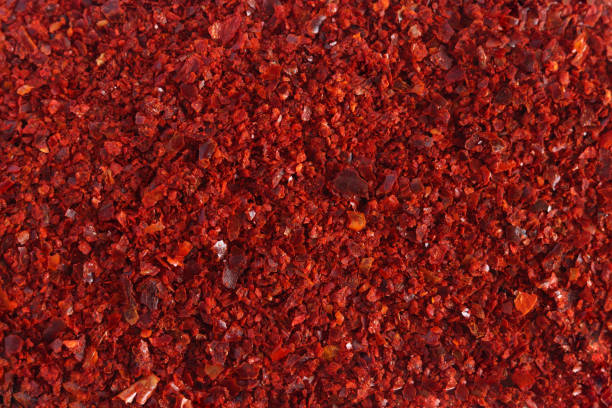 Heap of dried red chili flakes as background. Spices and herbs. Top view. Free space for text.