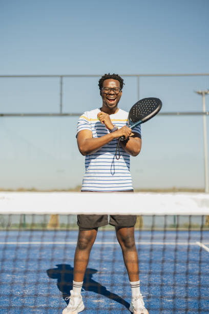 istock Man posing confidently with a paddle on the court 2206075055
