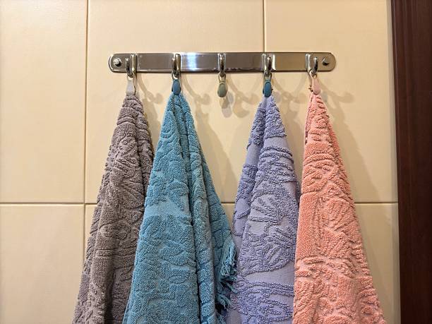 istock Four multi-colored towels on a silver-colored steel hanger 2206075258