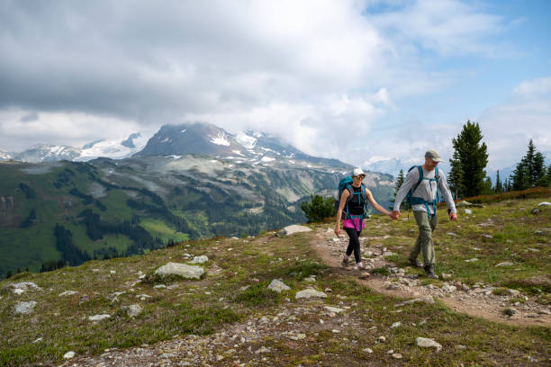 istock Couple hike pathway in mountain meadow 2206075277