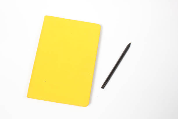 istock black pen and yellow book isolated on white background 2206075354