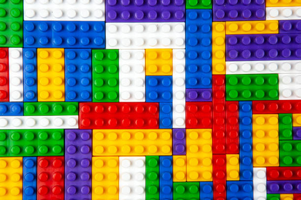 Abstract background texture of colored constructor blocks. Background of colorful plastic part of constructor. Pile of colored toy bricks.