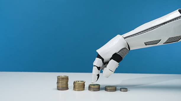 istock Robotic Arm Reaching for Stacks of Coins on Minimalist Surface 2206076098