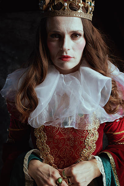 istock medieval queen in red dress with white collar and crown 2206076300