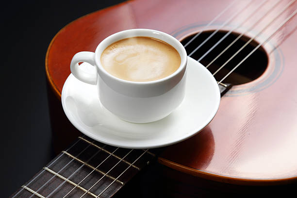 istock white cup with black coffee lying on the acoustic guitar 2206076645