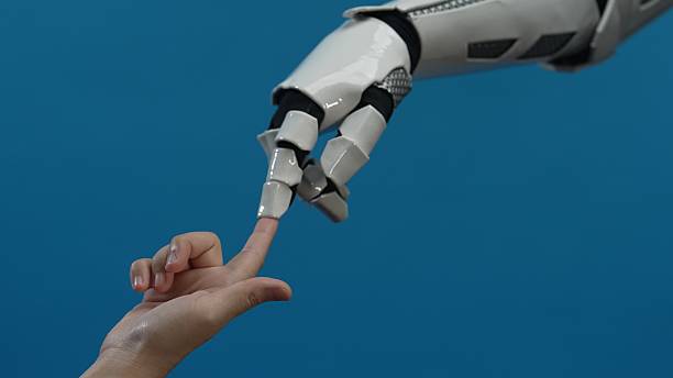 istock Human and Robot Finger Touching with Blue Background 2206077154