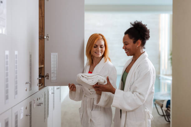 istock Two women enjoying conversation in a spa changing area 2206078018
