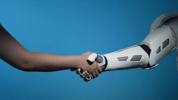 istock Human and Robot Handshake Symbolizing Collaboration and Innovation 2206078087