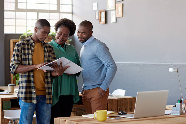 istock African businesspeople talking together over paperwork in a modern office 2206079363