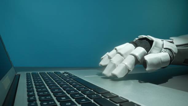 istock Futuristic Robotic Hand Reaching for Laptop Keyboard in Modern Office 2206079813