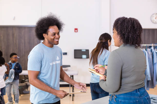 istock Volunteer helping people at a community event 2206080957