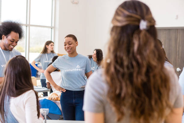 istock Smiling Volunteers Working Together at a Community Event 2206080965