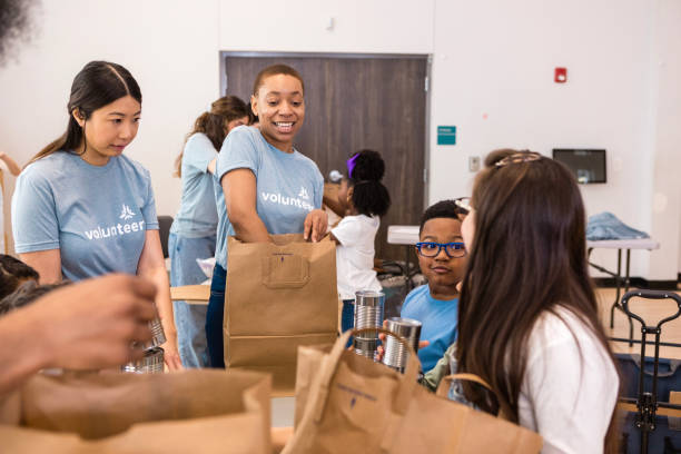 istock Volunteers Packing Food Donations for Charity 2206080976