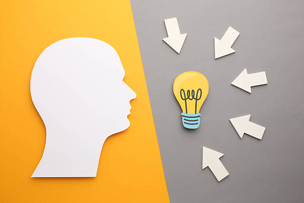 istock Creative thinking ideas and innovation concepts. A light bulb in yellow colour on the background. Human head with puzzle, jigsaw puzzle 2206082733