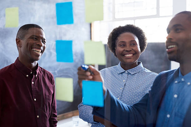 istock Smiling African work colleagues brainstorming in an office 2206083263