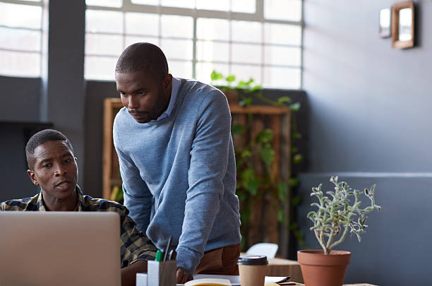 istock African coworkers using a laptop together in a modern office 2206083894