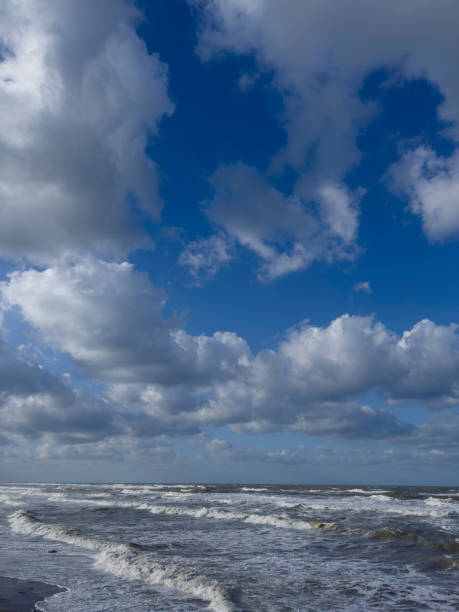 View of the stormy Baltic Sea against a cloudy sky on a sunny summer day, Curonian Spit, Kaliningrad region, Russia