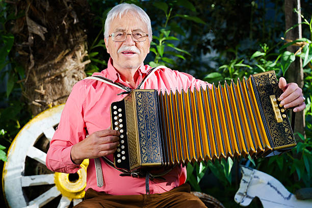 istock An elderly man is joyfully playing an accordion amidst a vibrant and colorful setting 2206085319