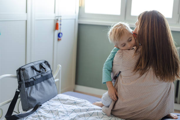 istock Mother embracing sleepy child in a cozy bedroom setting 2206086909