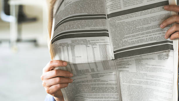 istock Woman reading newspaper 2206087993