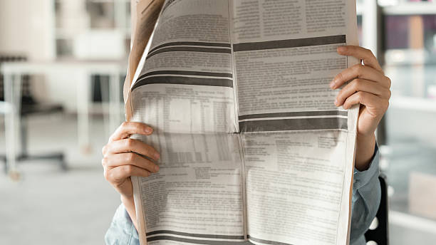 istock Woman reading newspaper 2206088001