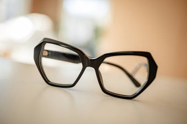 istock Modern black eyeglasses on a table with soft background lighting for fashionable eyewear enthusiasts 2206088975