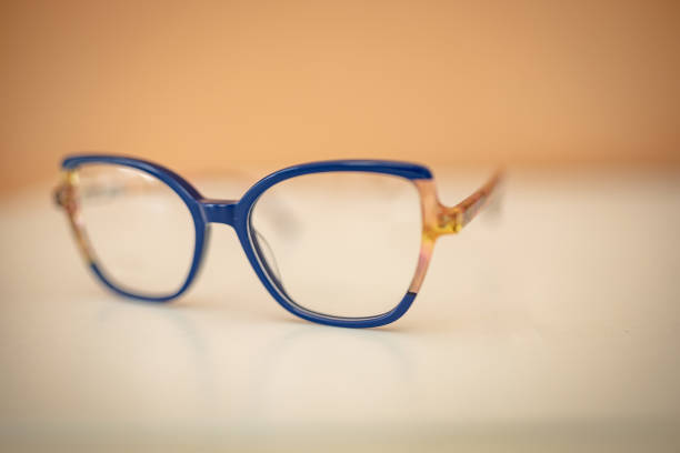 istock Modern eyeglasses resting on a white surface with a soft orange background indoors 2206089234