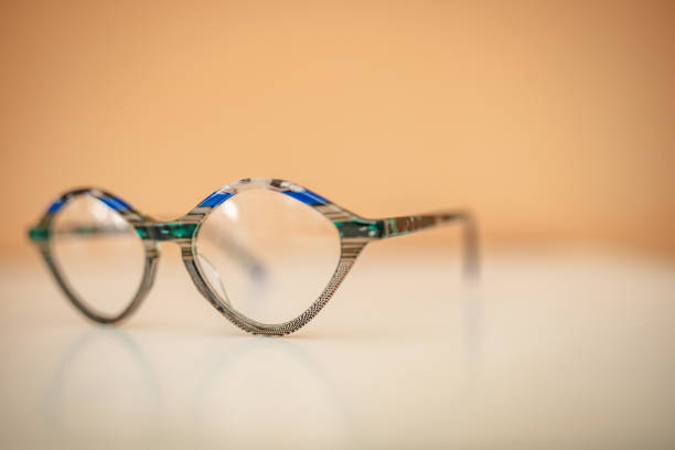 istock Modern fashionable eyewear in stylish shape placed on a smooth surface against a warm background 2206089513