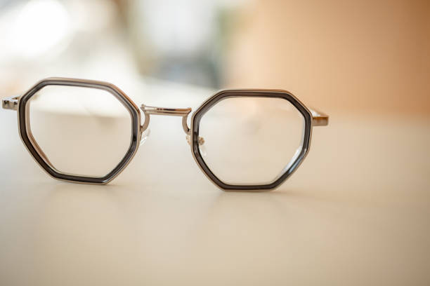 istock Modern octagonal eyeglasses showcased on a minimalist surface in a well-lit environment 2206089874