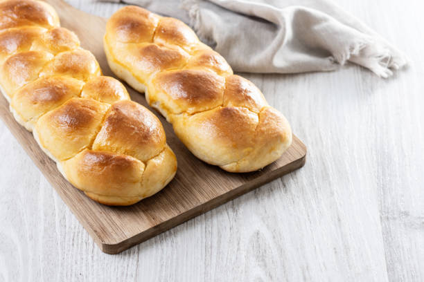 istock Traditional Easter braided bread. Tsoureki braid on white wooden table 2206091382