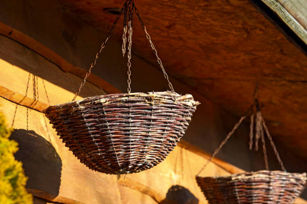 istock Two wicker baskets hanging in front of a wooden facade 2206095047