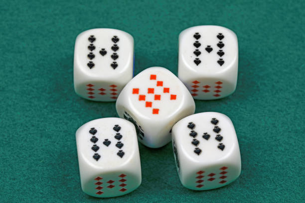 An old fashioned game show with a host and assistant watching the contestant throw jumbo dice. Photographed in studio with a purpose built set and props.