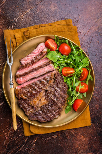 istock Dinner with Grilled Rib eye steak, fried dry aged beef meat. brown background. top view 2206095225