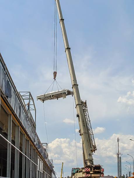 istock A large crane is lifting a piece of construction material at an urban construction site. 2206099677