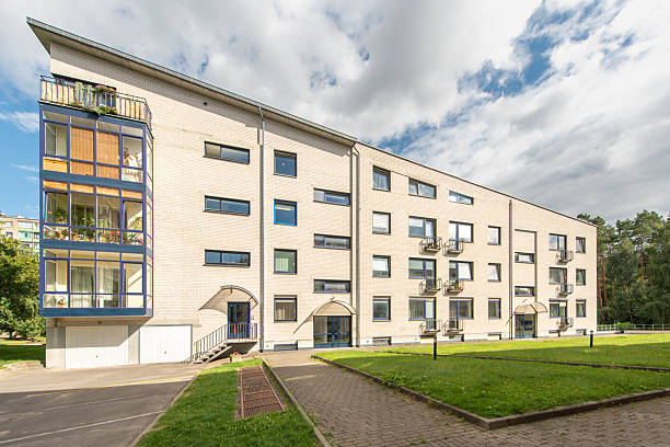 istock Modern Residential Building With Courtyard Surrounded by Greenery and Trees 2206101577