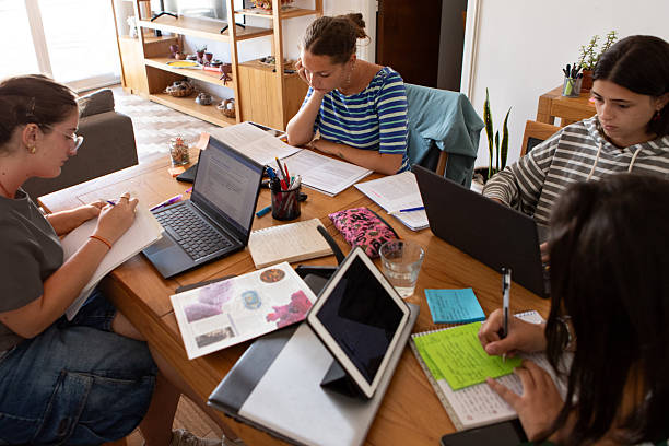istock Latin American roommates studying in their student housing 2206102268