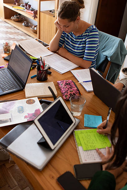 istock Latin American roommates studying in their student housing 2206102345