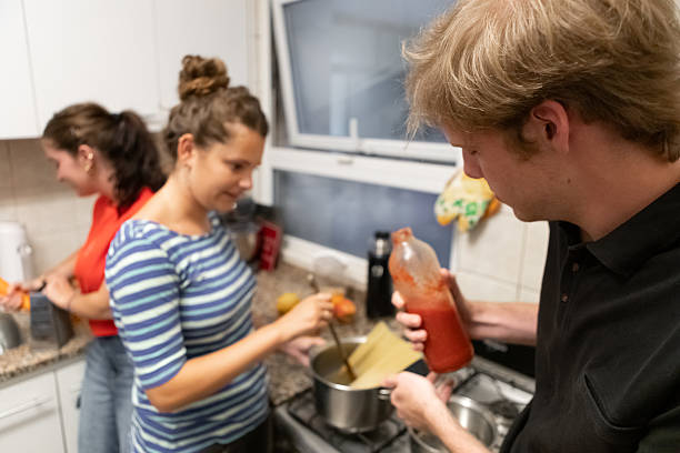istock Latin American roommates preparing for dinner 2206102358