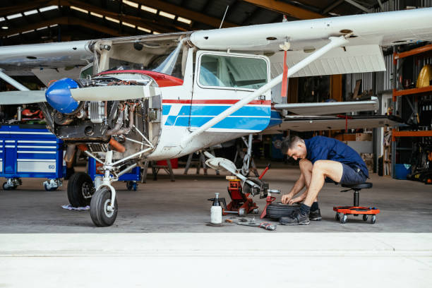 istock Technician fixing the tire in the airplane hangar 2206103806