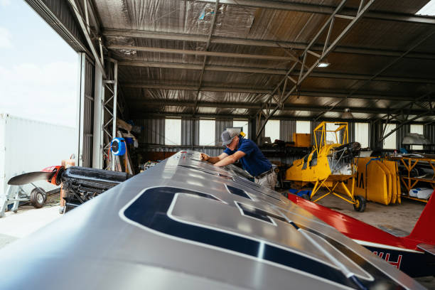 istock Experienced engineer fixing private airplane, connecting cables in the wings 2206103828