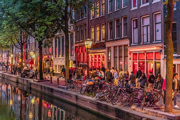 istock Picture of Red Light District lined with people and river in foreground 2206104818