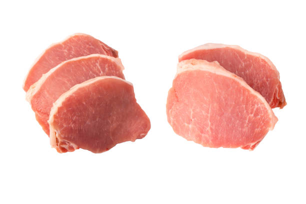 Raw pork pieces isolated on a white background. Top view.