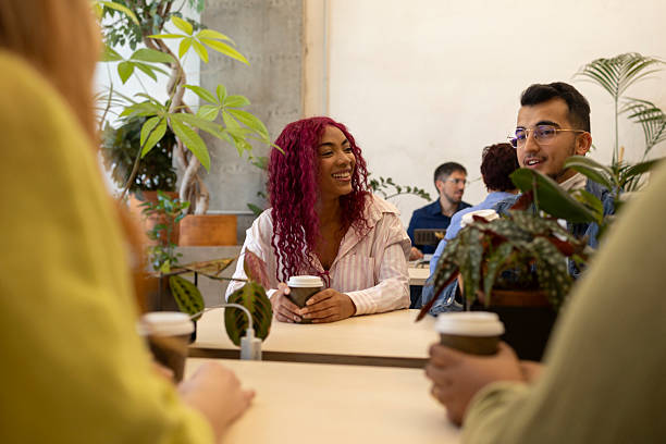 istock Coworkers enjoying coffee break in green office space 2206109426