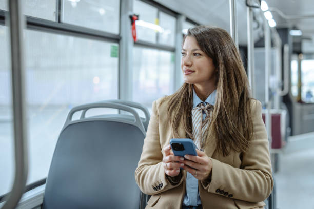 istock Professional woman using smartphone on a city bus during transit 2206110686