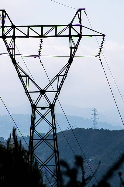 istock Electricity towers stand on scenic hills 2206110818