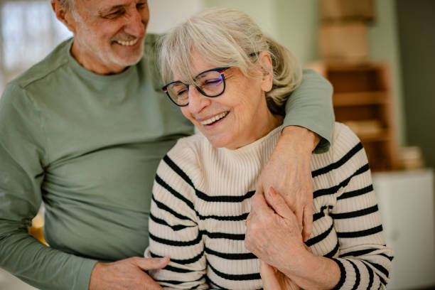 istock Senior couple joyfully decorating their new home together while embracing change and new beginnings 2206110909