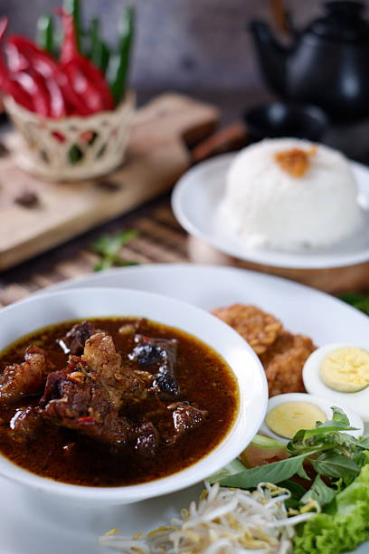 istock Rawon is an Indonesian beef soup. Originating from East Java, rawon utilizes the black keluak nut as the main seasoning, which gives a dark color and nutty flavor to the soup. Nasi Rawon, telur asin 2206115538
